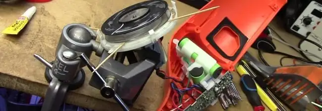 Vacuum cleaner repair parts and tools on a workbench in Atlanta, GA