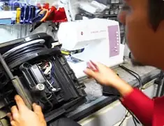 Vacuum repair technician servicing internal components on a workbench in Atlanta, GA